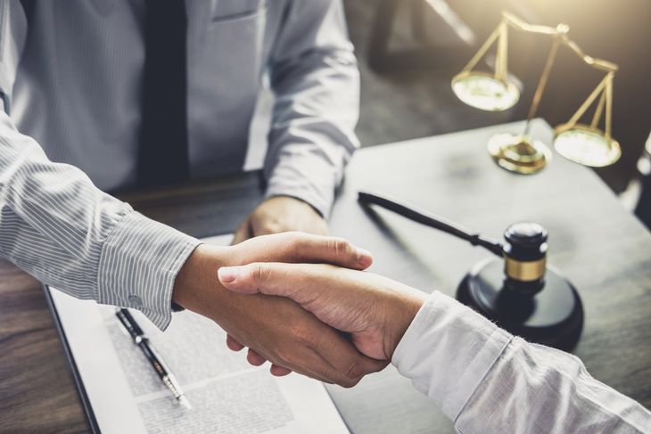 Attorney Near Me — Lawyer and Client Shake Hands in Southfield, MI