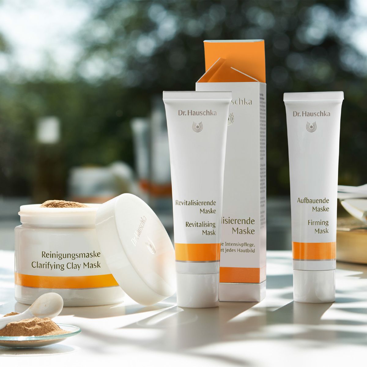 a statue of an elephant is sitting on a window sill next to a box of cosmetics.