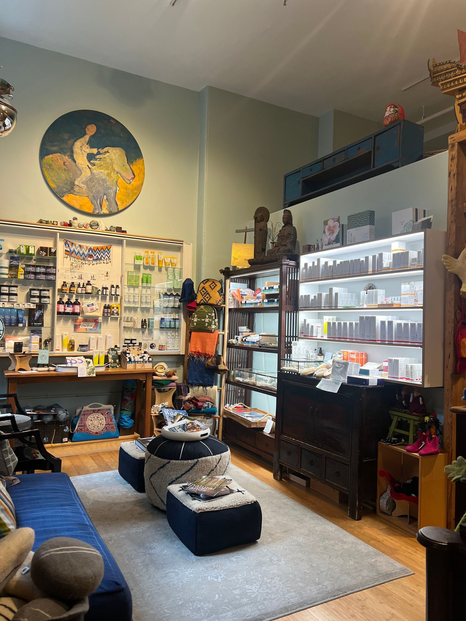 a living room filled with furniture and a painting on the wall