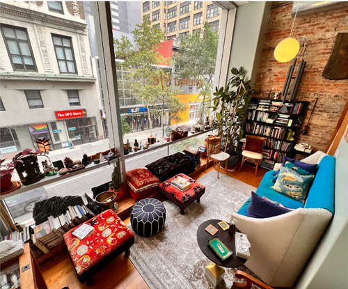 a living room with a couch and ottomans in front of a ups store