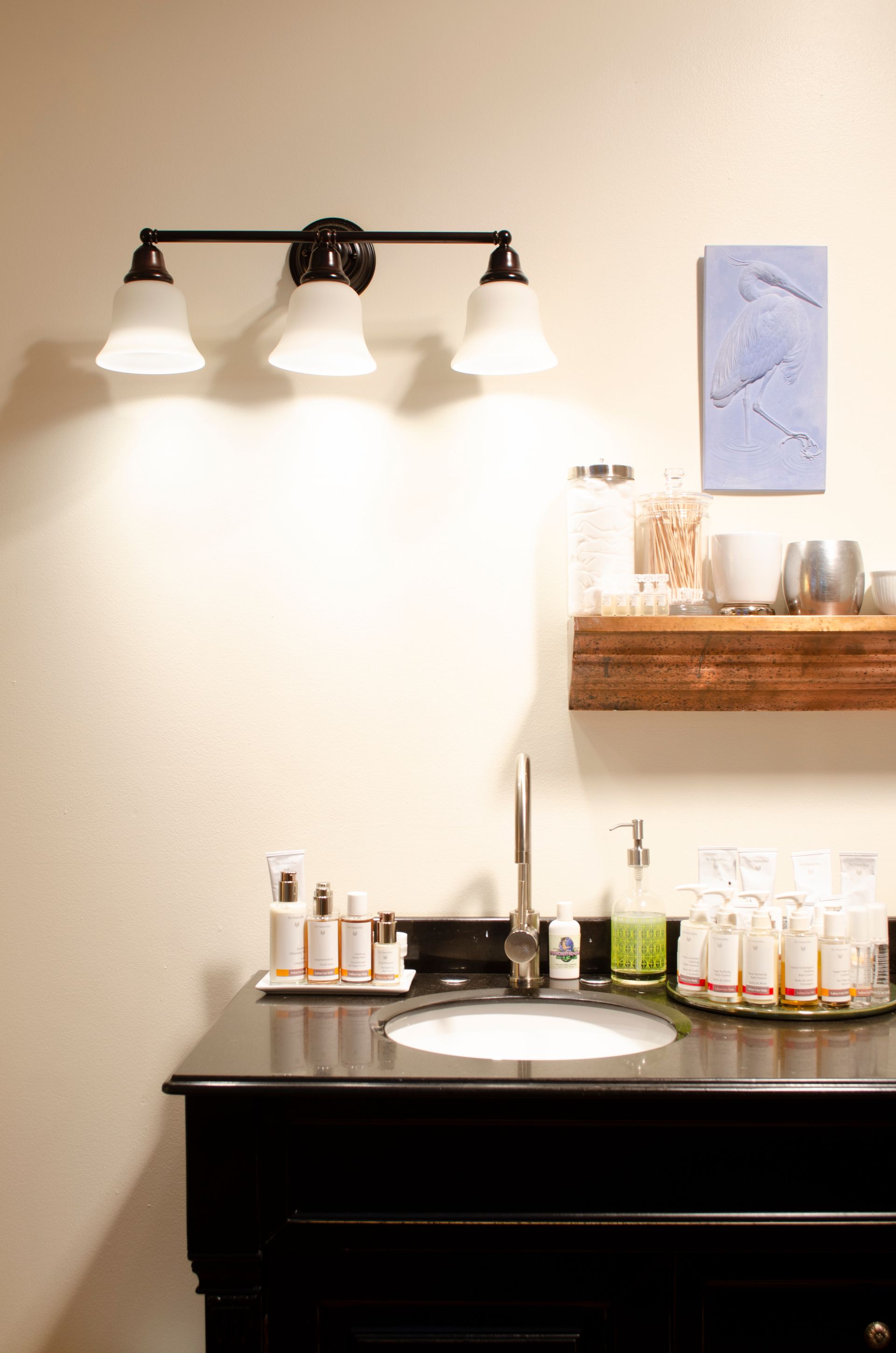a bathroom with a sink , mirror , and a shelf .