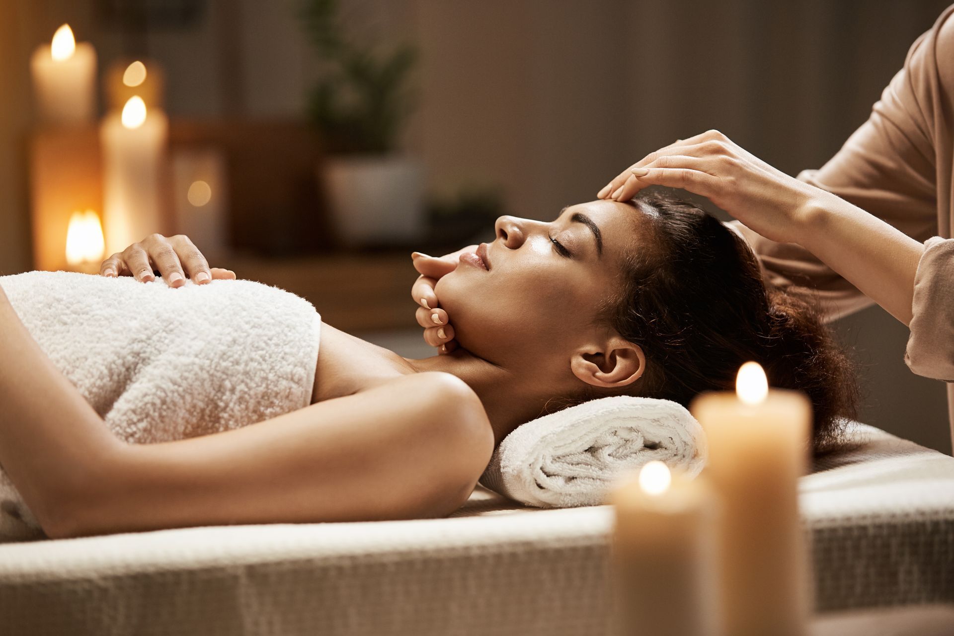 a woman is getting a head massage in a spa