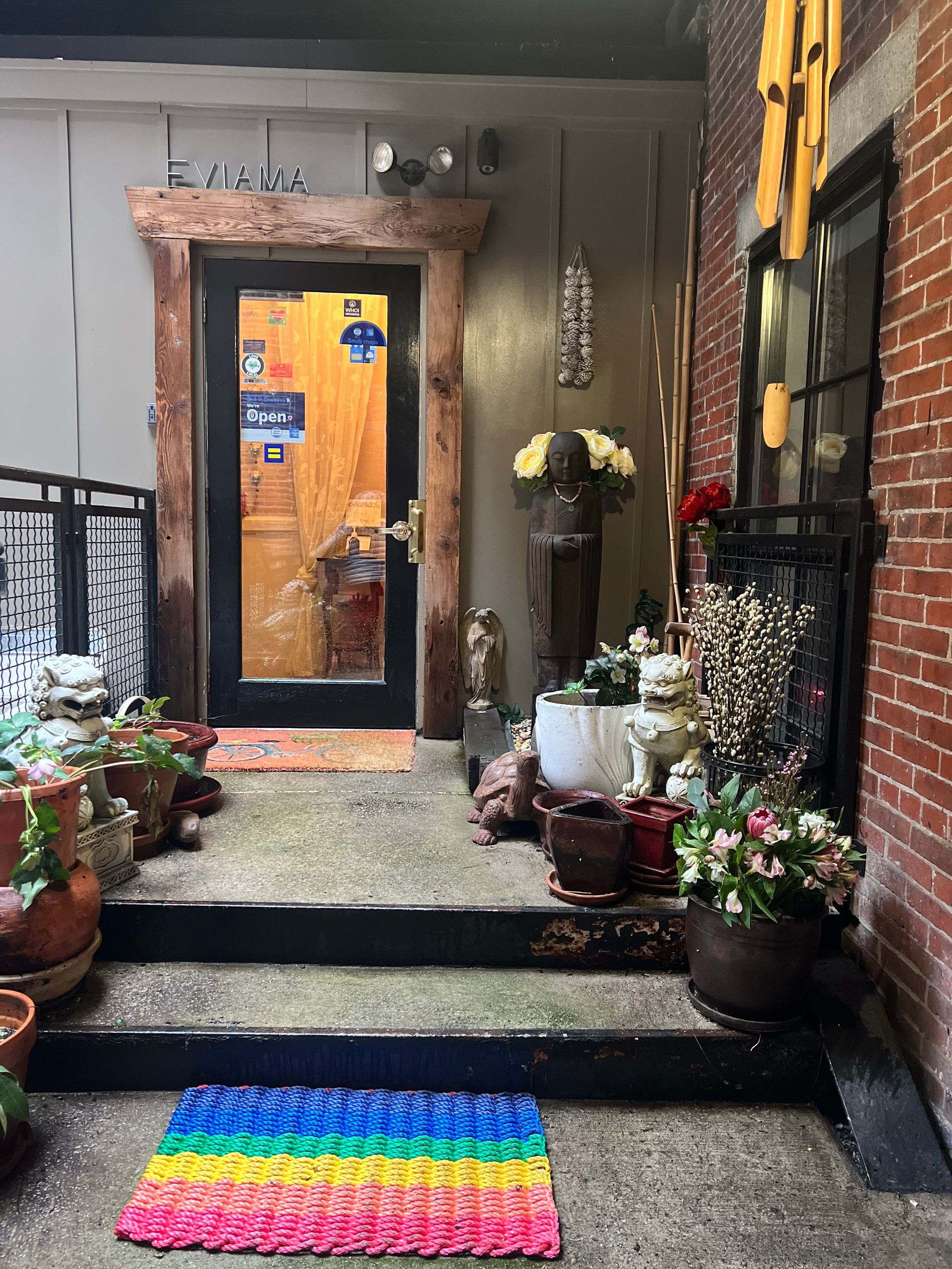 a rainbow rug is on the porch of a building .