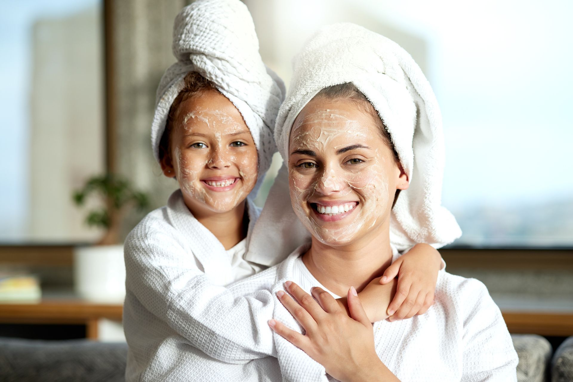 a woman and child with towels wrapped around their heads and face masks on their faces