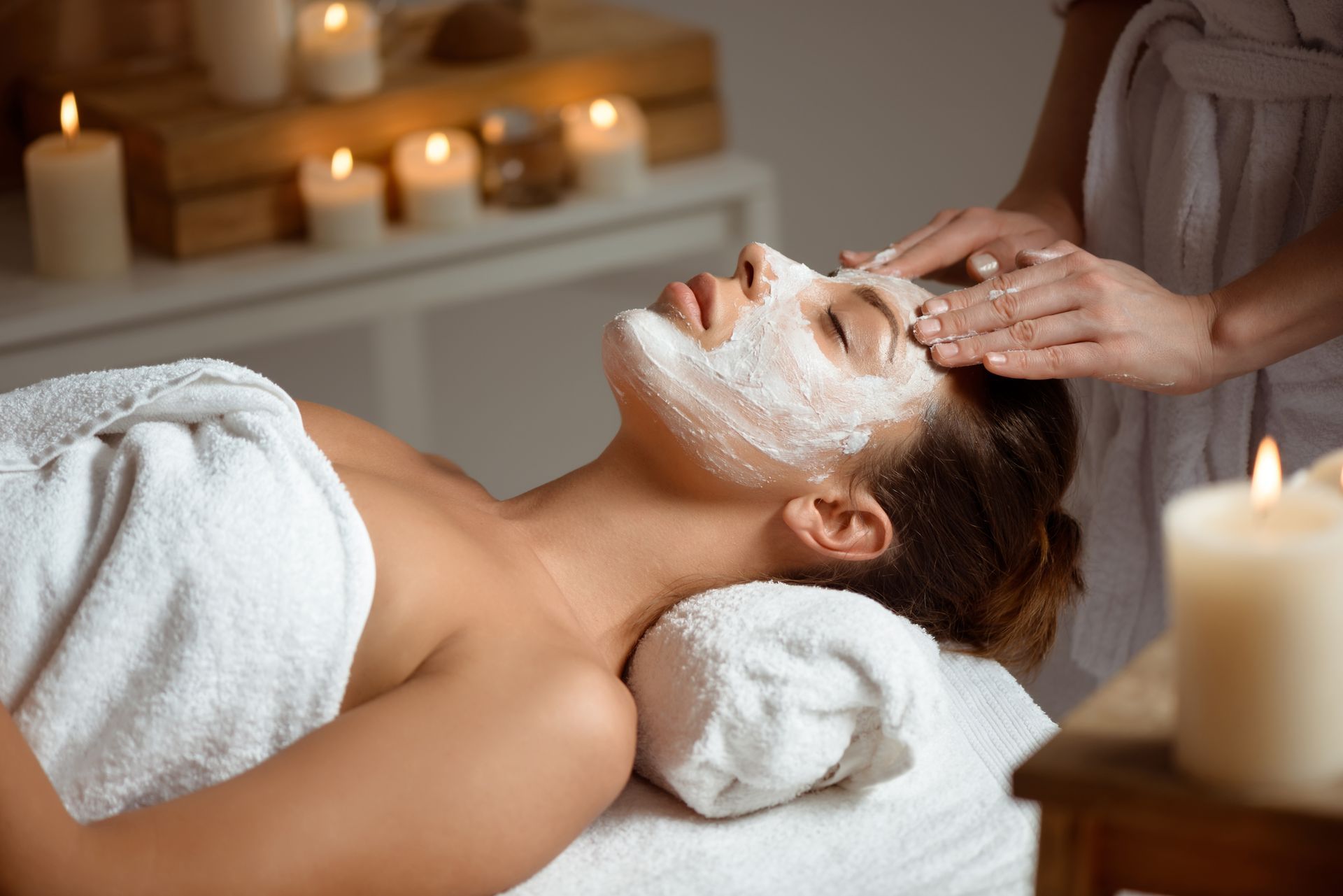 a woman is getting a facial treatment at a spa