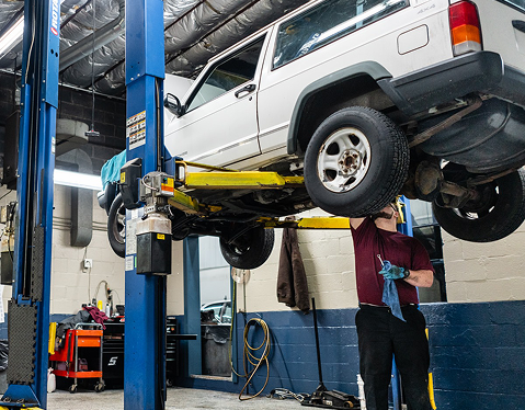 Mechanic working under car | KARS