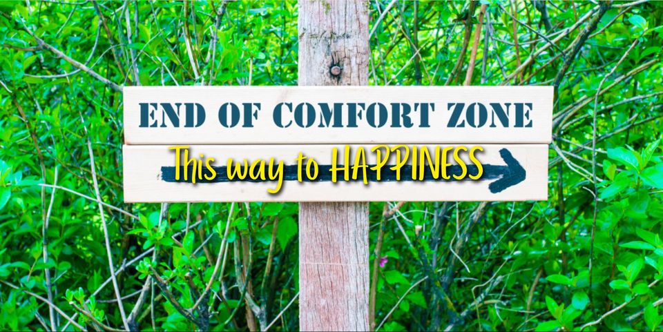 sign in woods saying End of Comfort Zone, This way to HAPPINESS