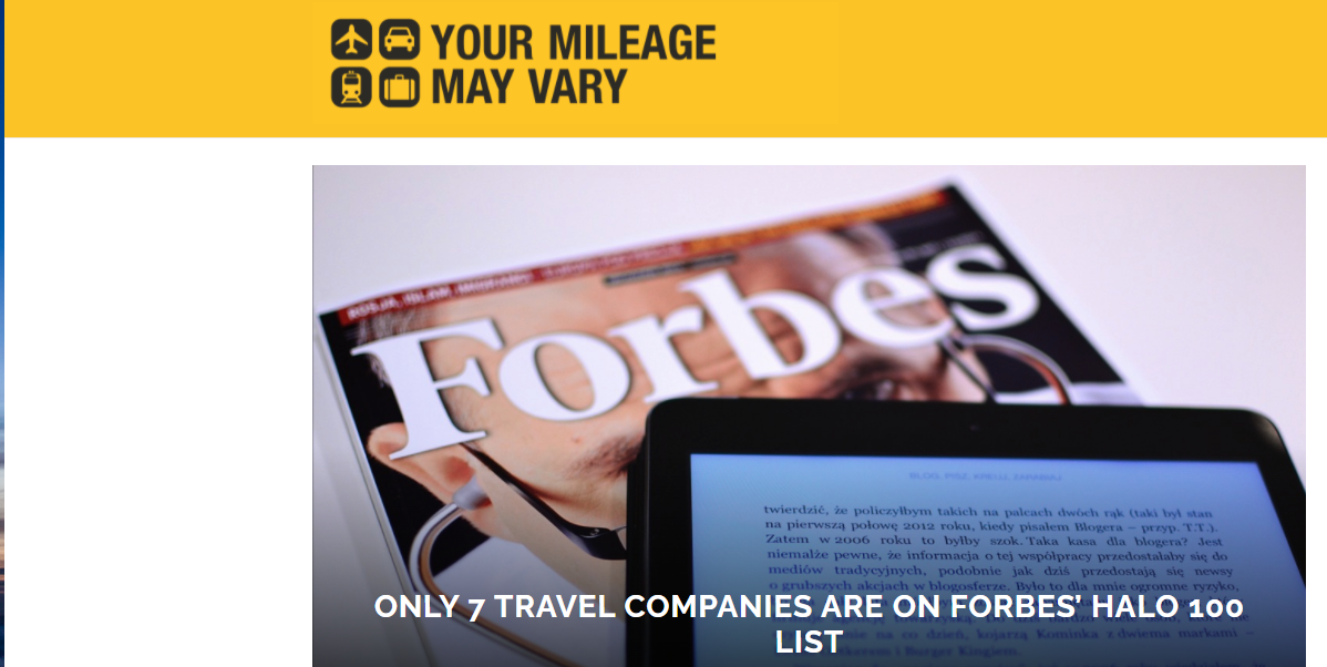 A forbes magazine is displayed next to a tablet