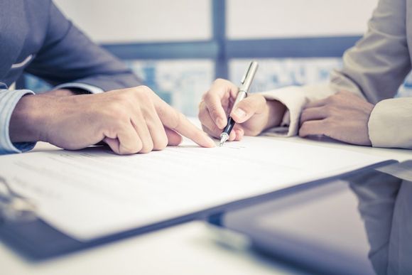 man signing the papers