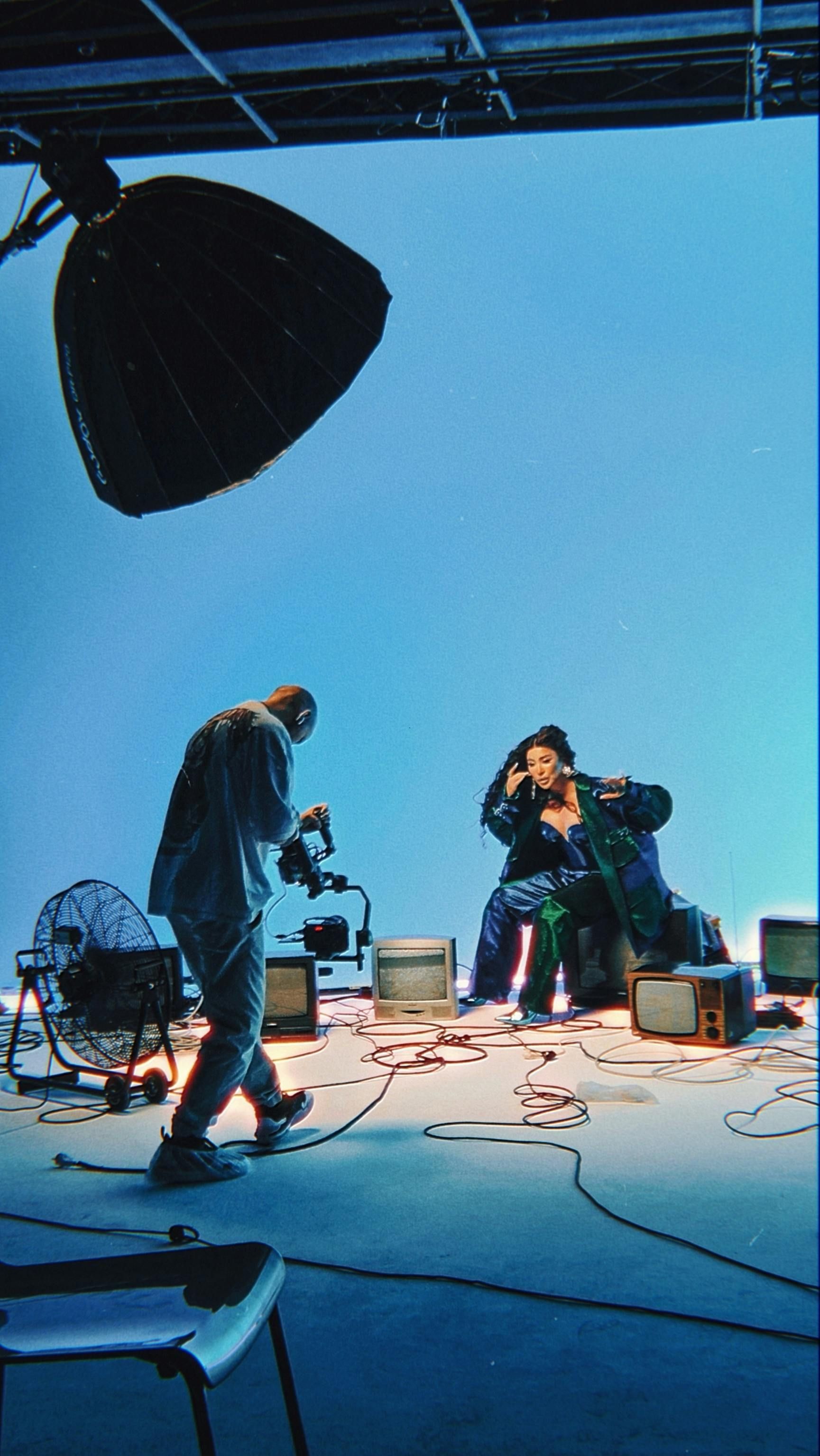 A man is taking a picture of a woman in a chair