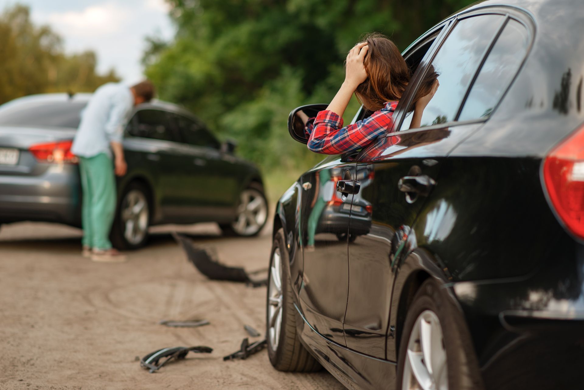 Car accident scene with damaged vehicles and distressed drivers after a collision