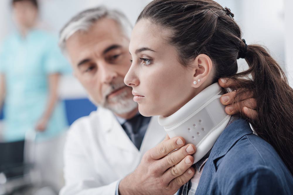 Misdiagnosis Attorney — Doctor Checking Patient With Cervical Collar in Chicago, IL