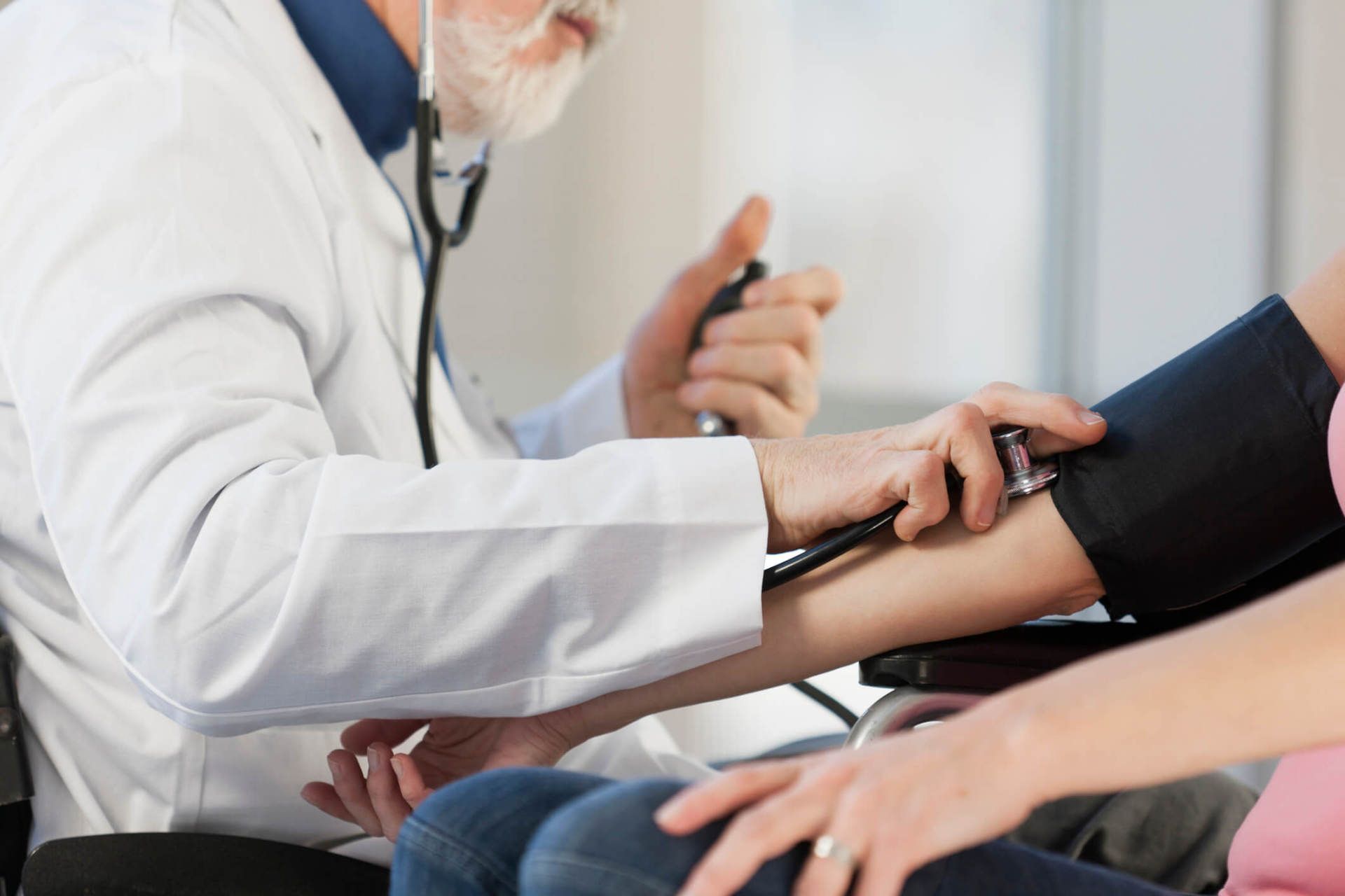 Malpractice Attorney — Doctor Checking the Blood Pressure of a Patient in Chicago, IL