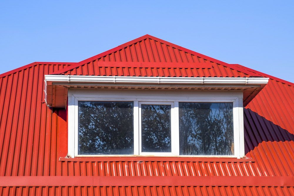 House With Red Corrugated Sheet Roof — Enduro Shield Roofing Solutions in Elanora, QLD