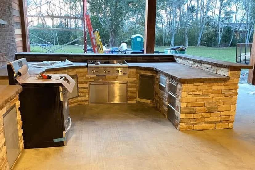 A kitchen with stainless steel appliances and brick counter tops is being built.