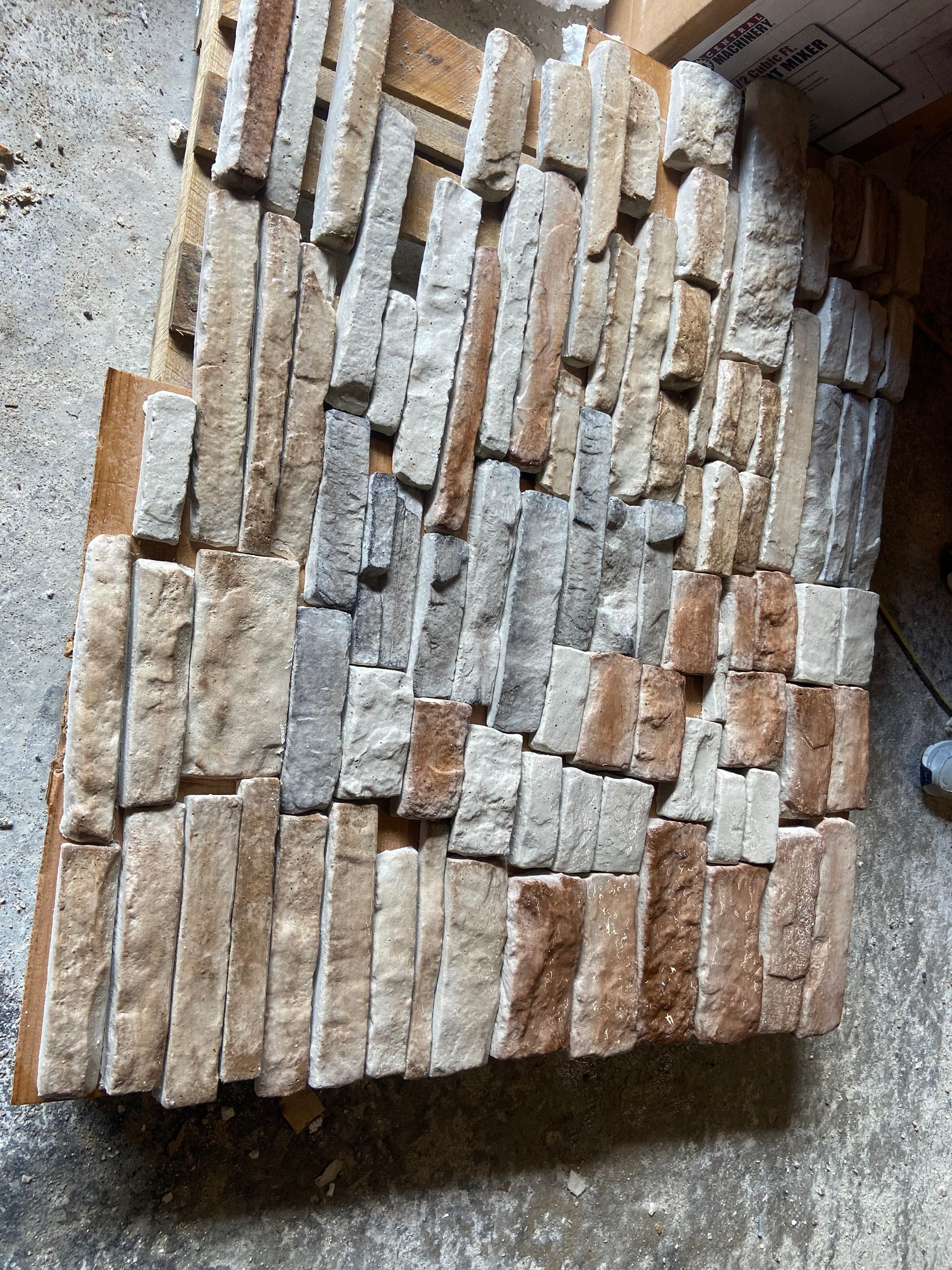 A pile of bricks is sitting on a concrete surface