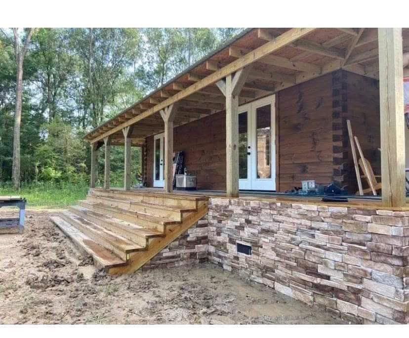 A wooden house with a porch and stairs