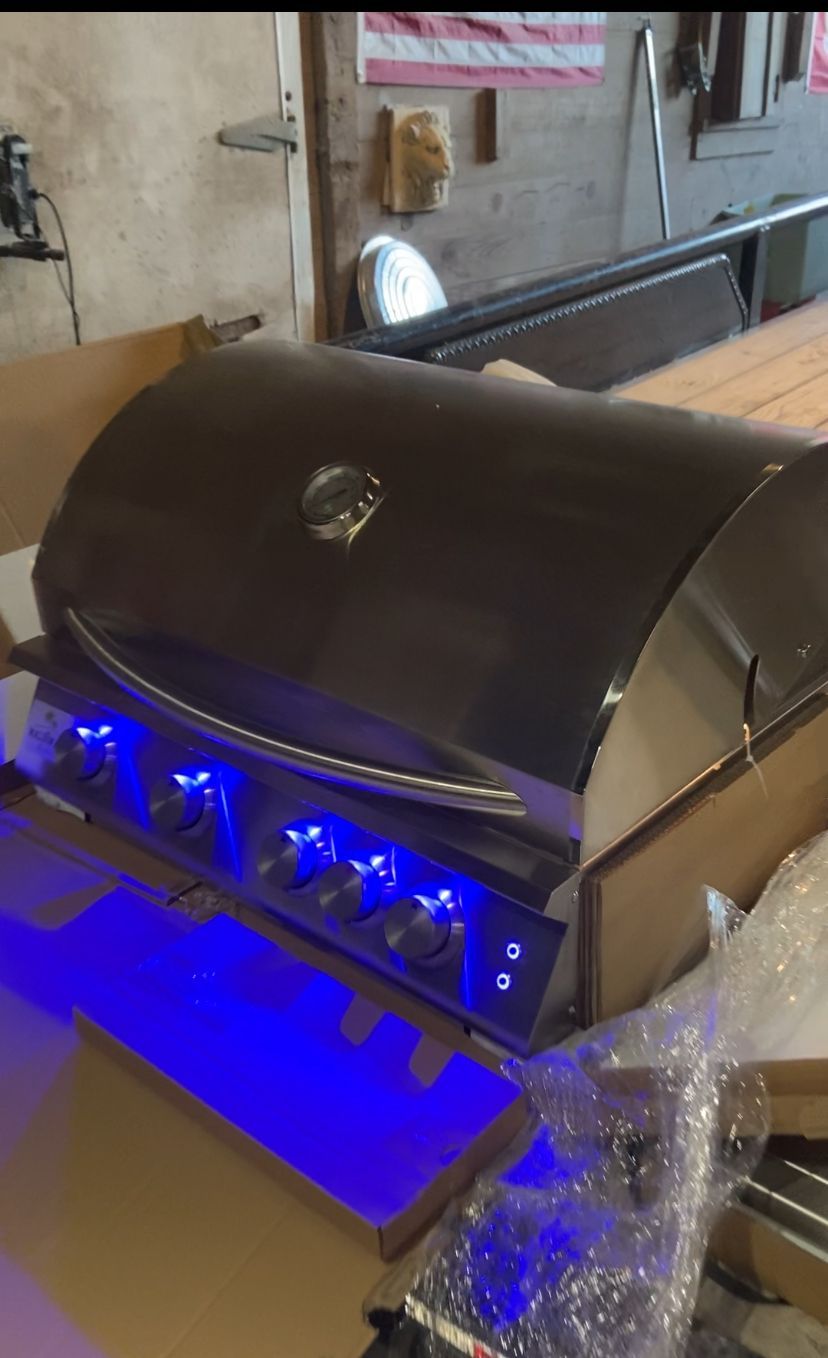 A grill with blue lights on it is sitting on a table.