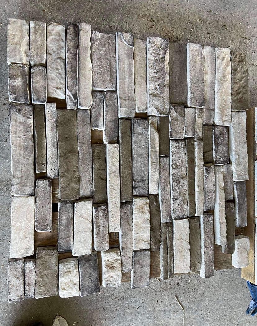 A pile of bricks sitting on top of a concrete surface.