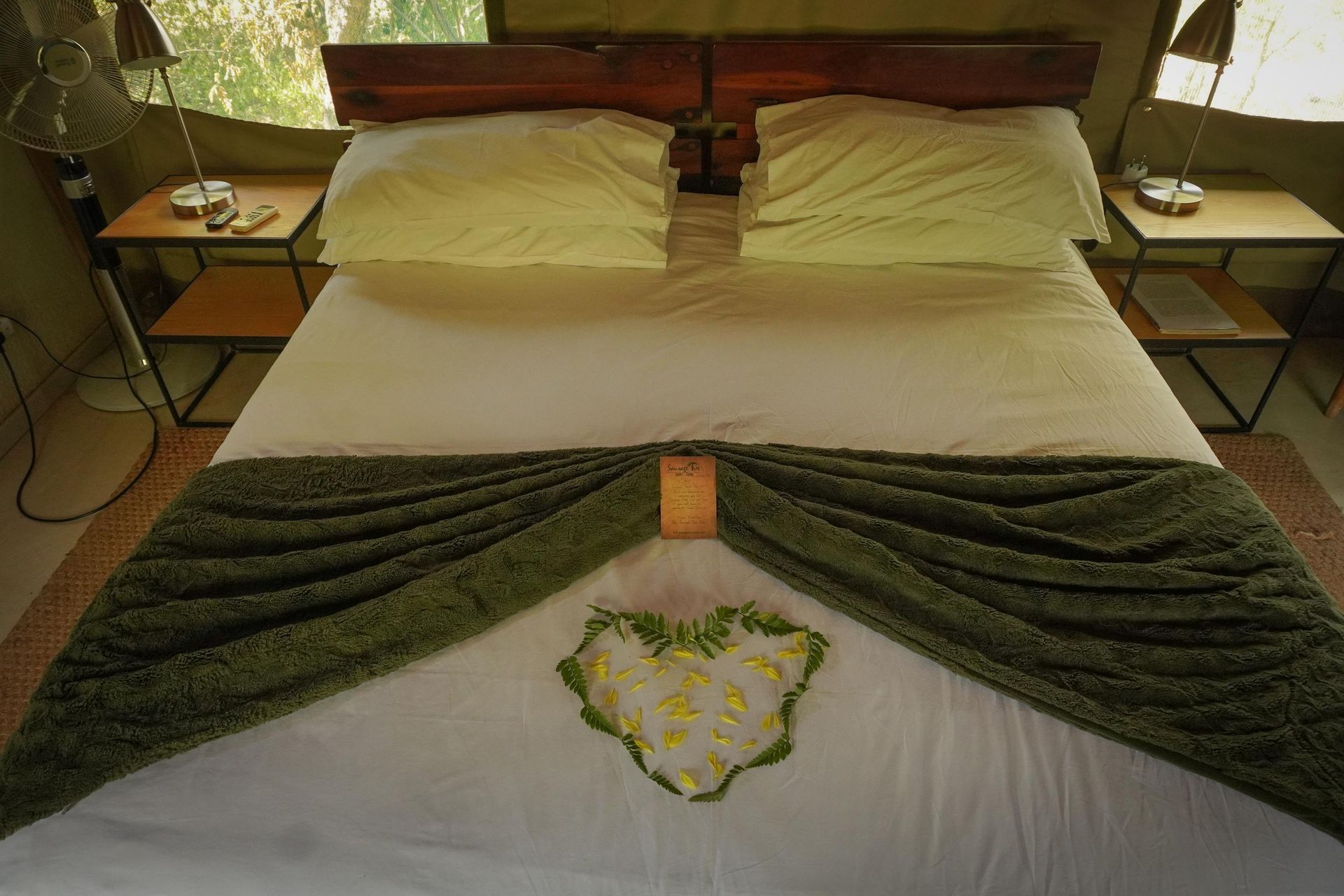 A bed with a heart made of flowers on it