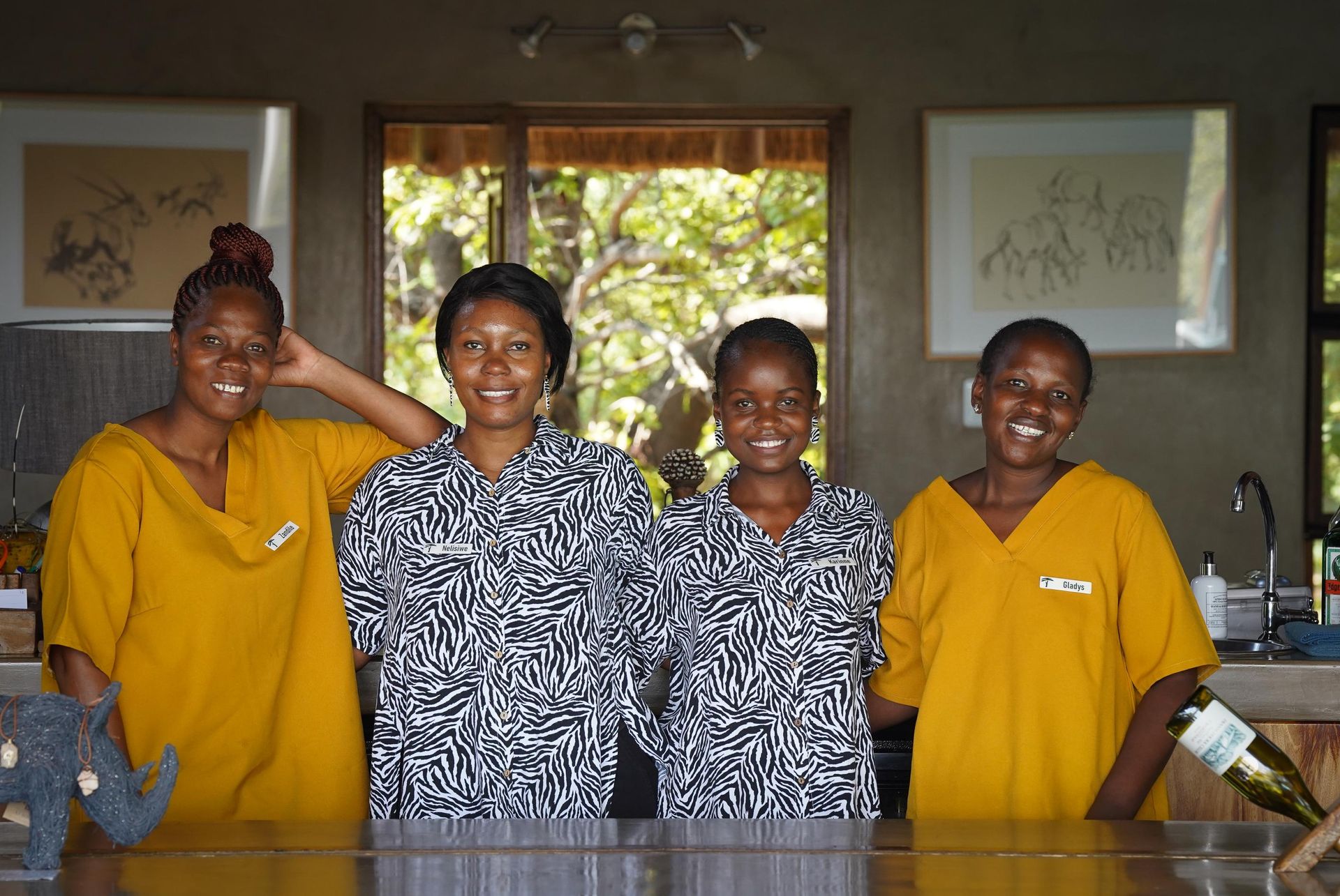 A group of women are posing for a picture in front of a counter.