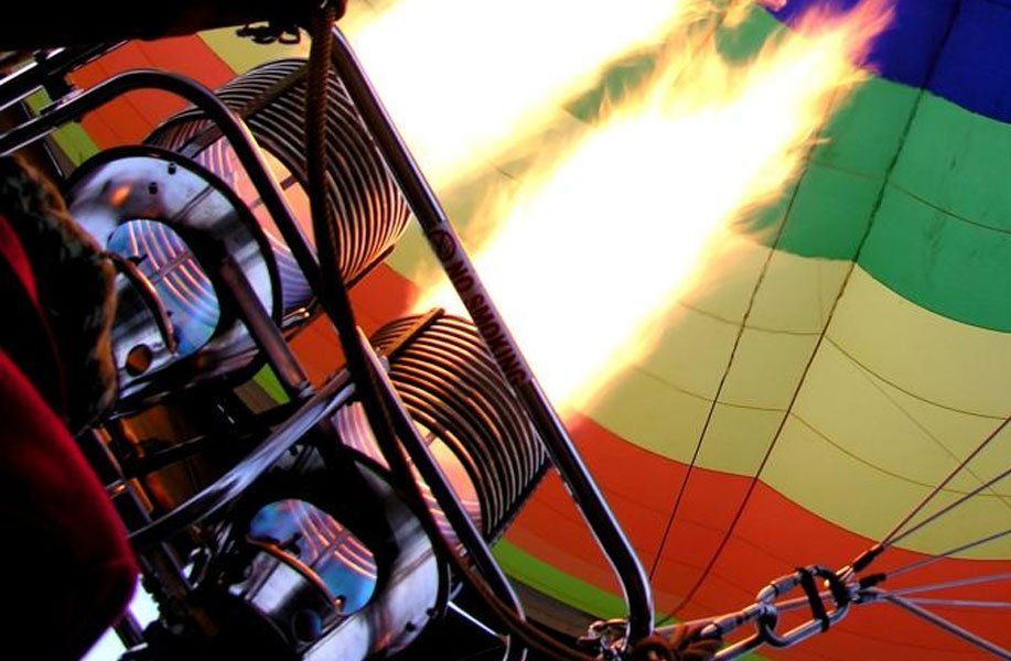 A hot air balloon with flames coming out of it