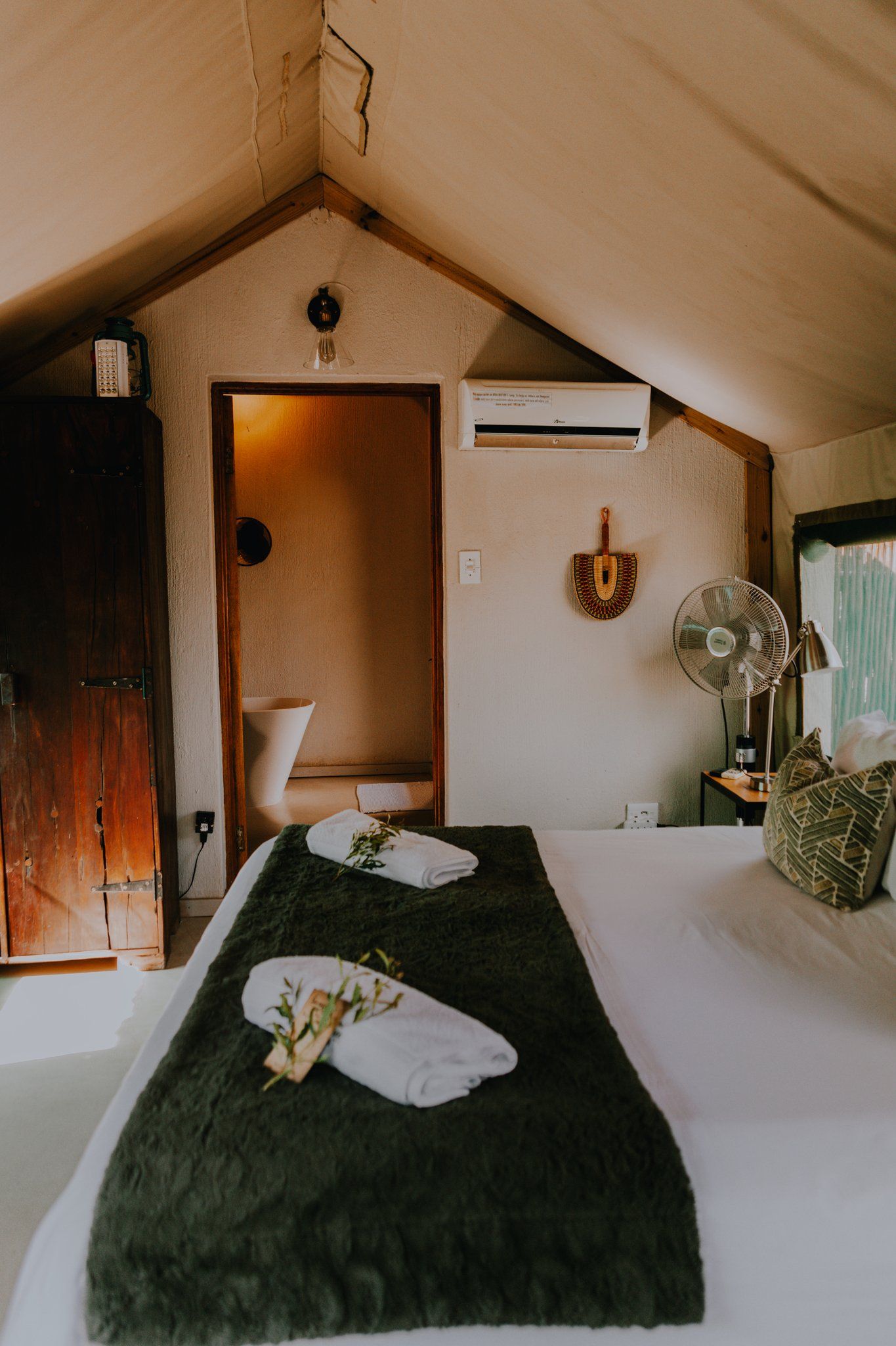 a bedroom with a king size bed and a fan