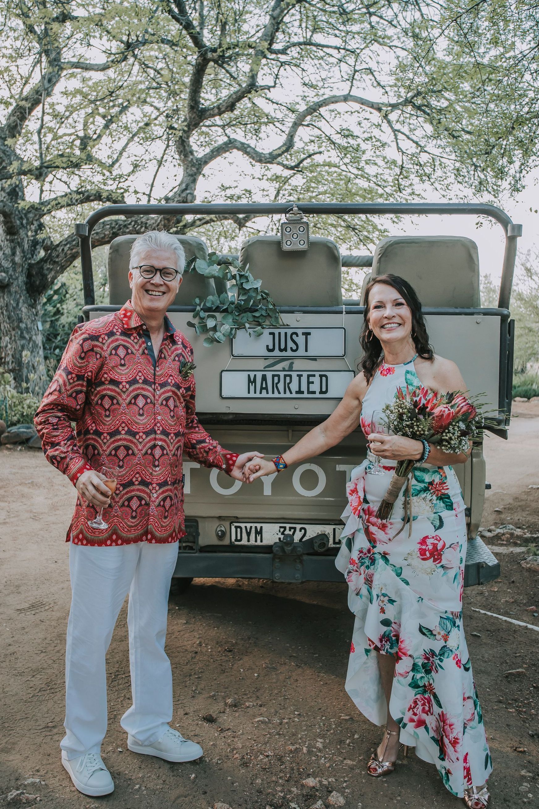 a couple standing in front of a toyota truck that says just married