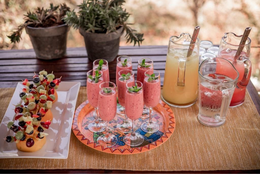 A table topped with plates of food and drinks.