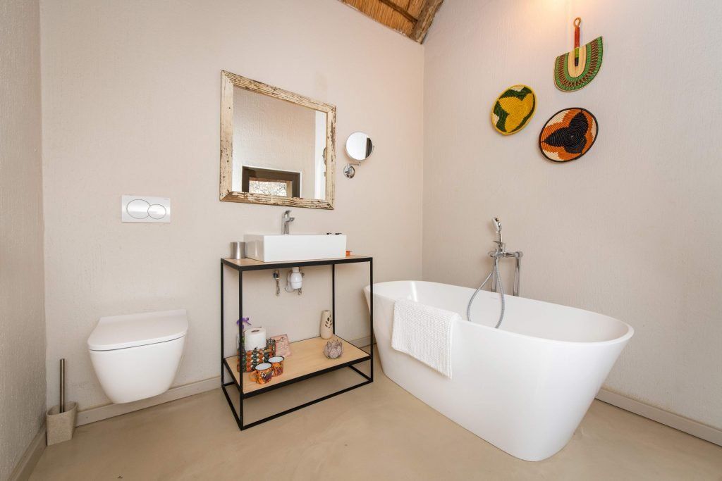 a bathroom with a bathtub a sink and a mirror