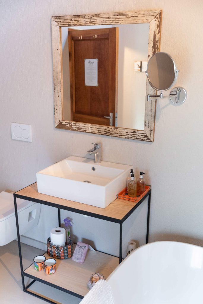 a bathroom with a sink and a mirror with a sign on the door that says ' a ' on it
