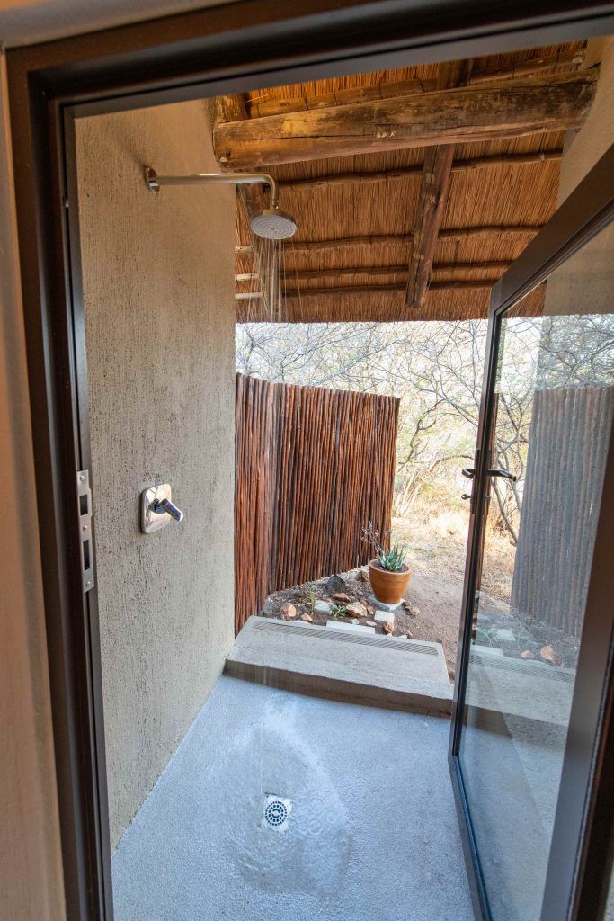 a sliding glass door leads to an outdoor shower