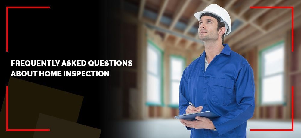 A man wearing a hard hat and overalls is holding a clipboard.