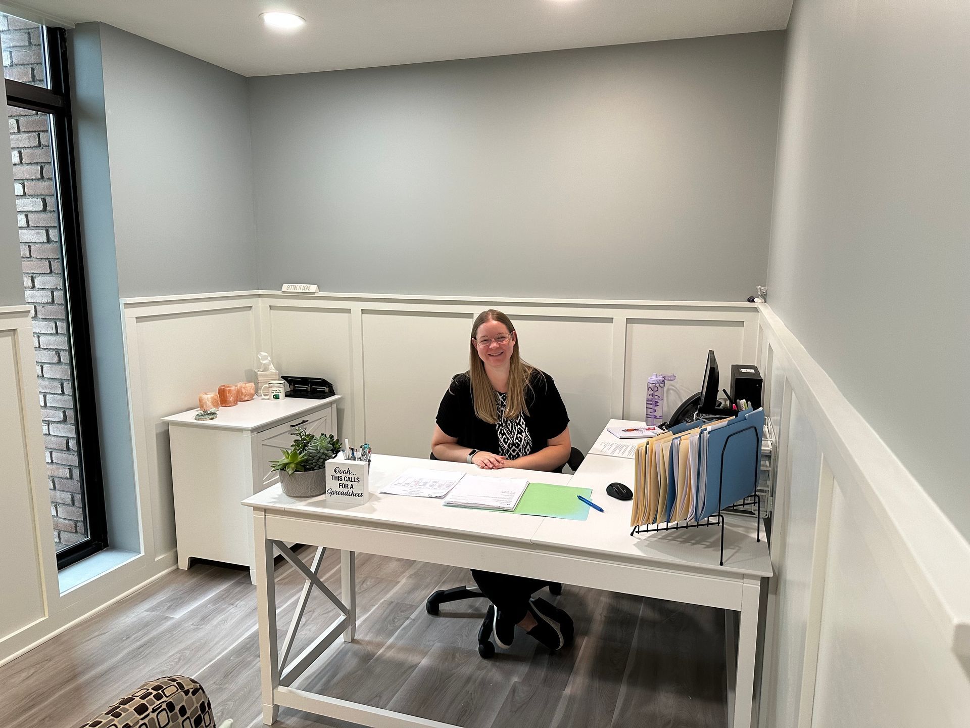 Stacy sitting at her desk