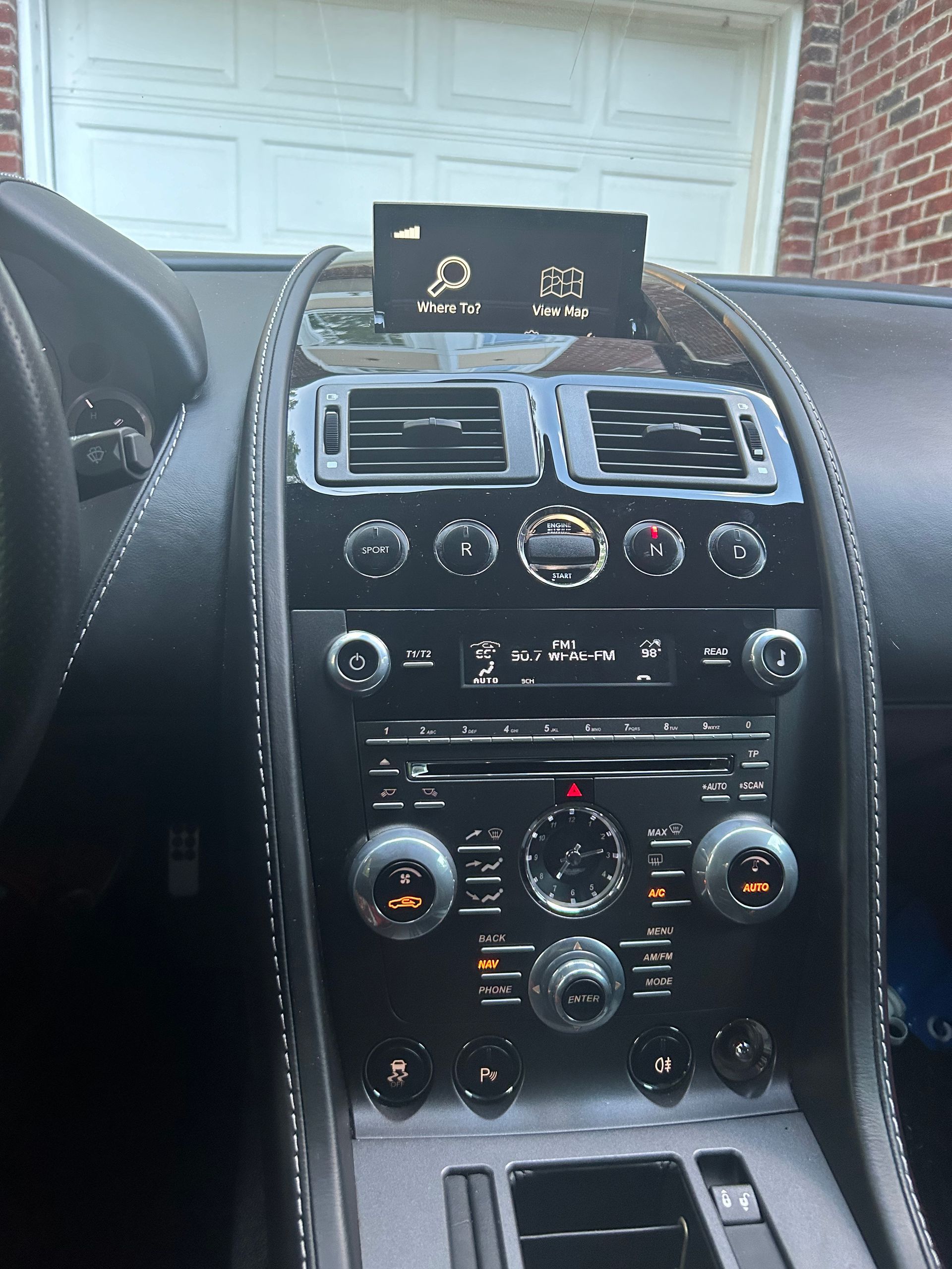 The dashboard of a car with a clock on it