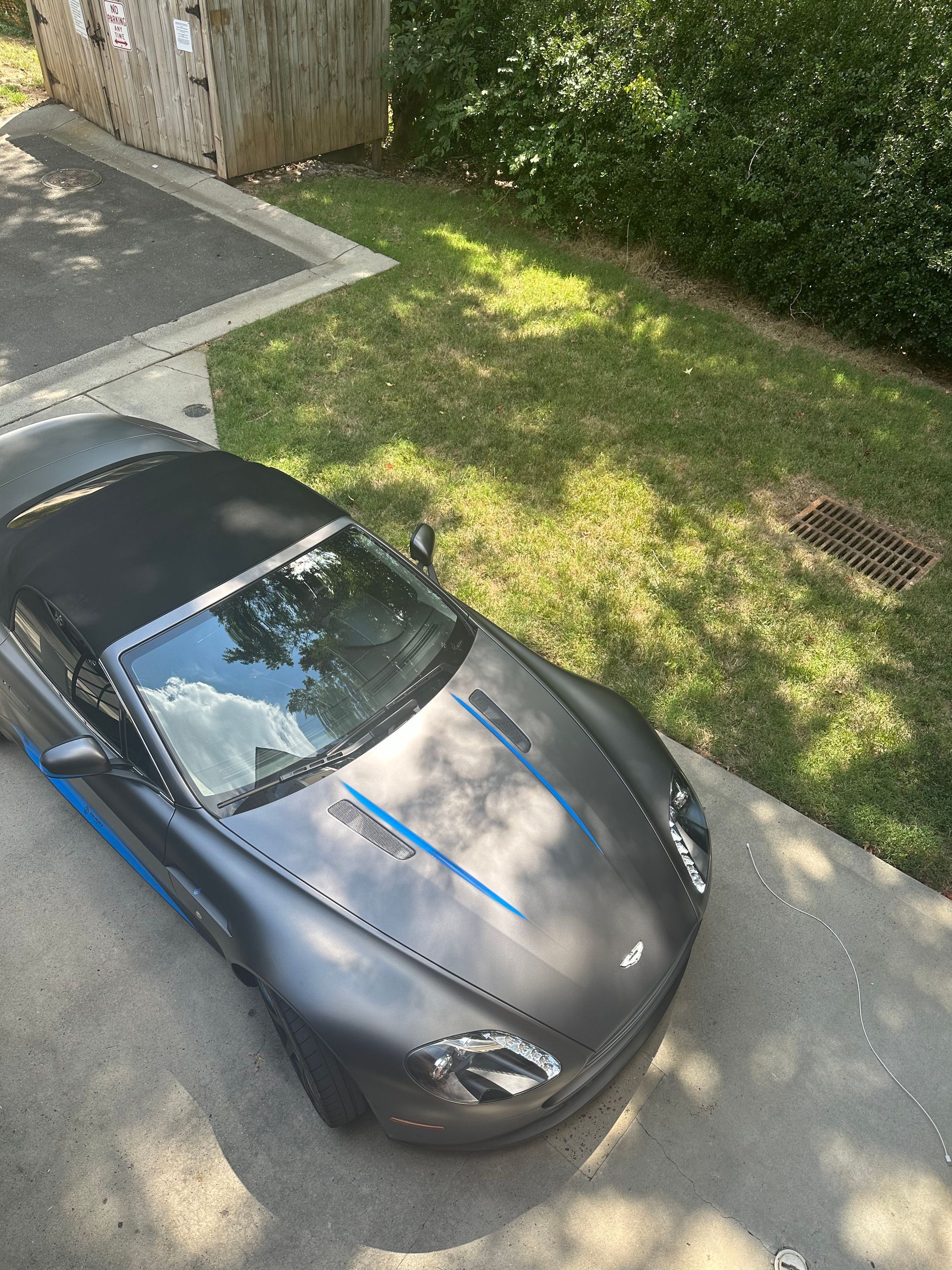 An aerial view of a sports car parked in a driveway