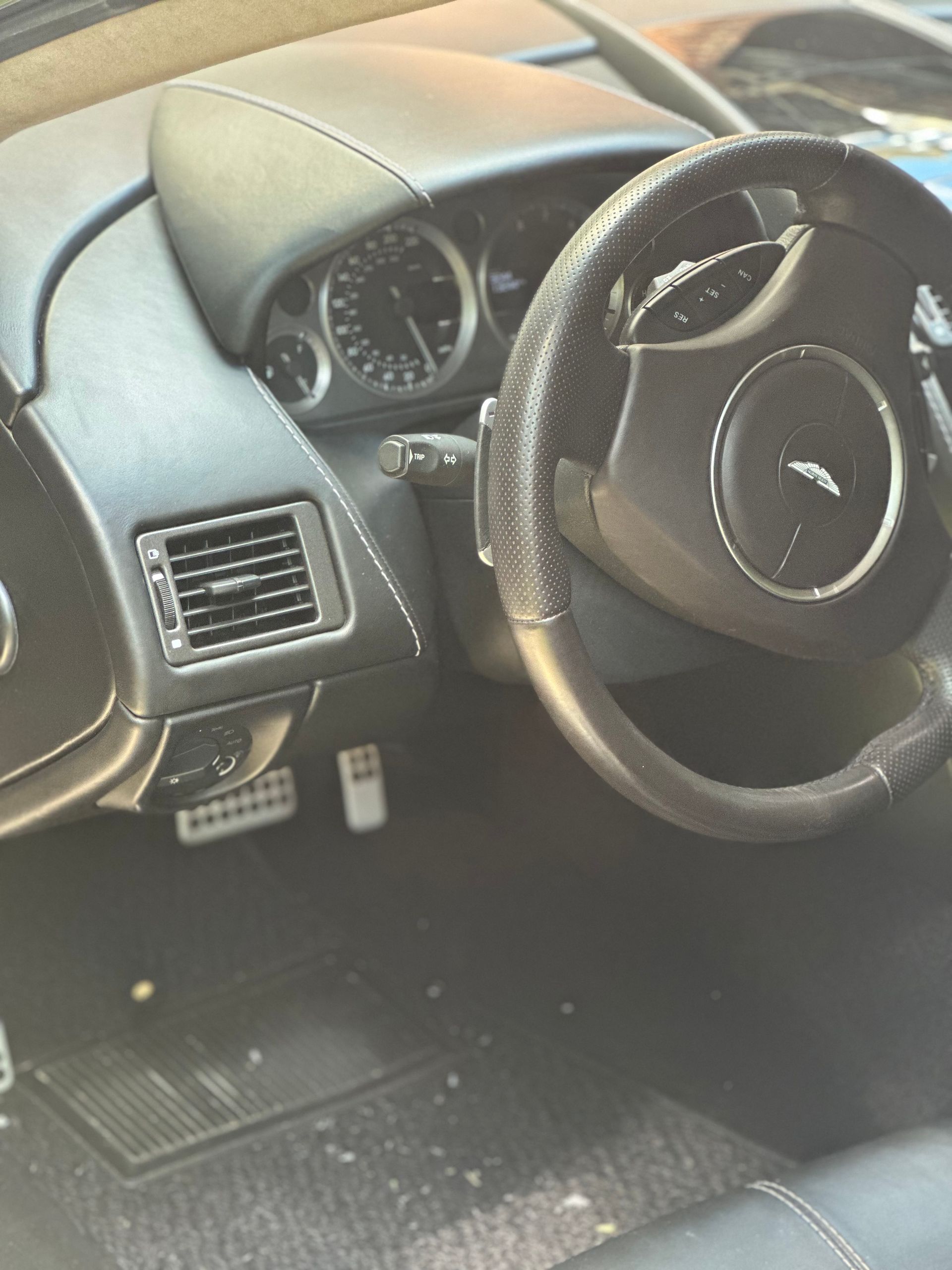 The inside of a car with a steering wheel and dashboard