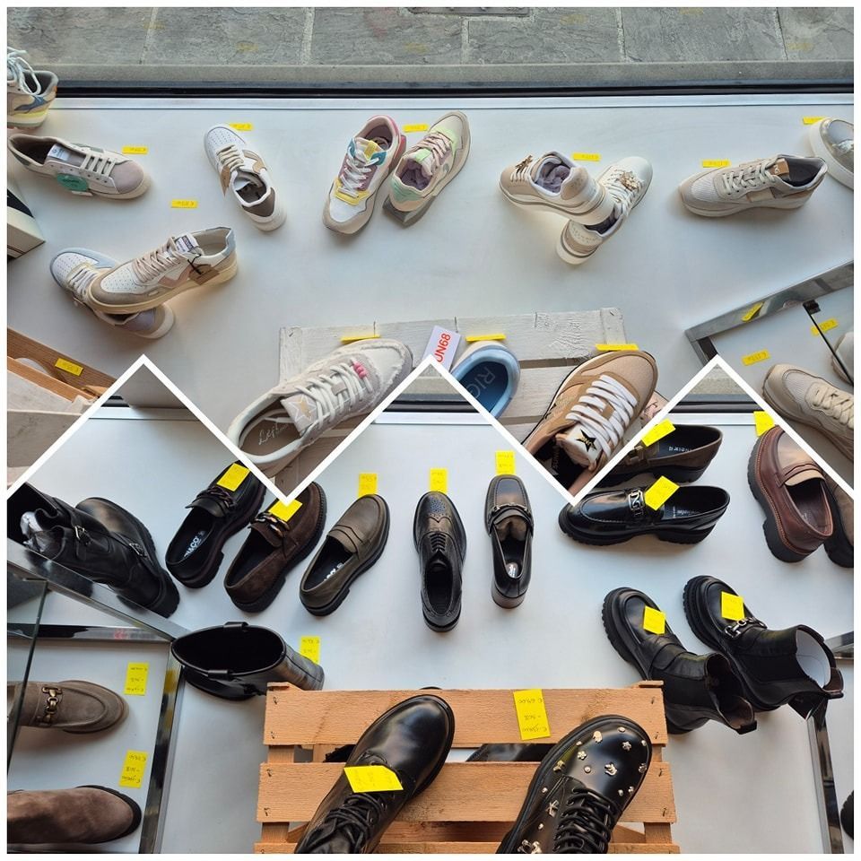 Scarpe esposte in vetrina. Le sneakers sullo scaffale più alto, le scarpe eleganti su quello più basso, vari colori e stili.