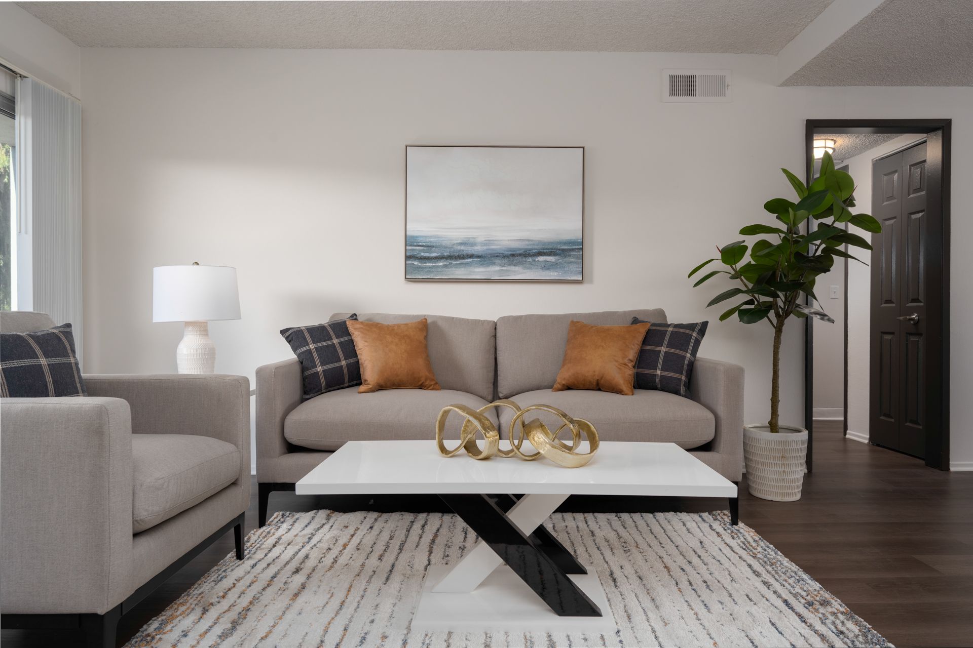 a living room with a blue couch and a white coffee table .