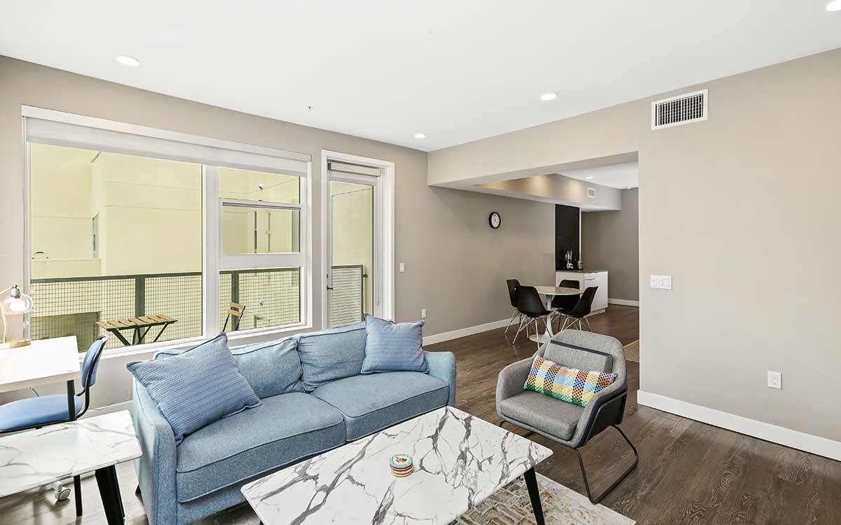 a living room with a blue couch and a white coffee table .