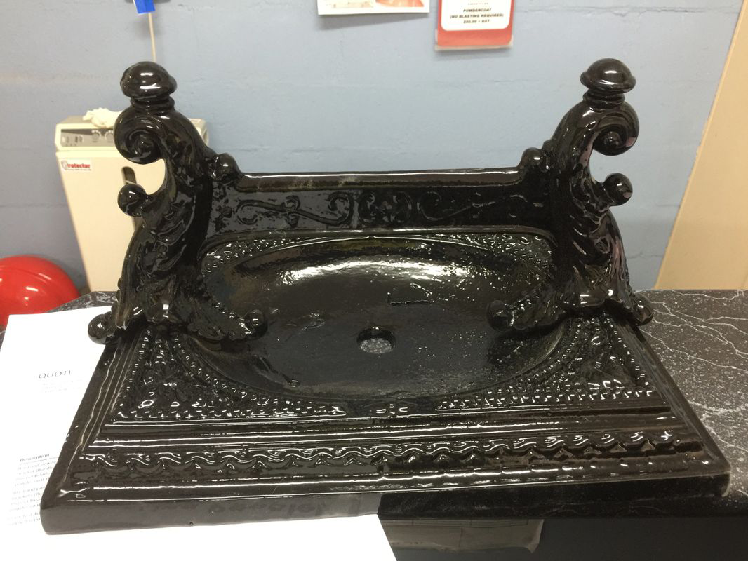 A black statue with a hole in the middle of it