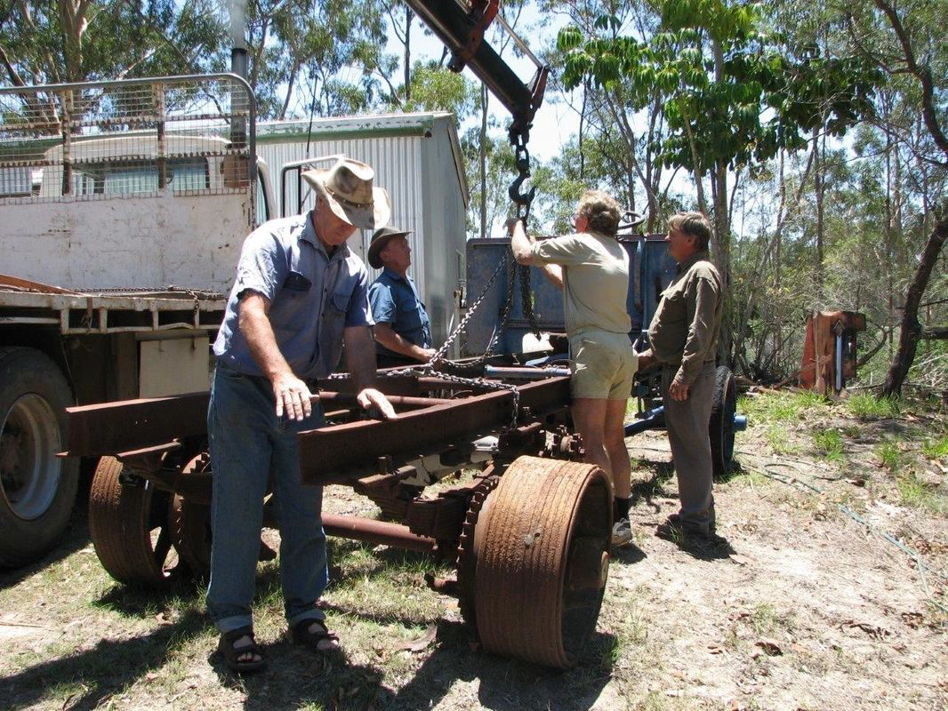 A group of men are working on a piece of metal