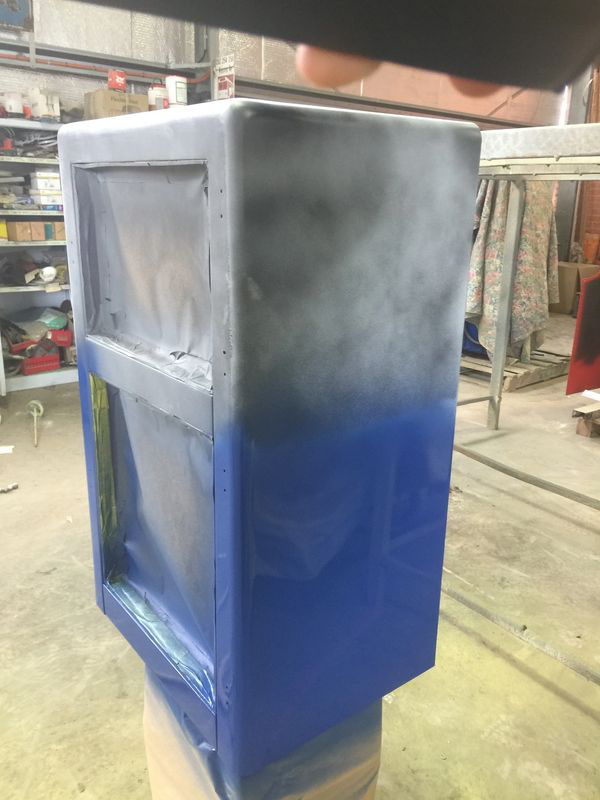 A blue box is sitting on top of a wooden table in a room.