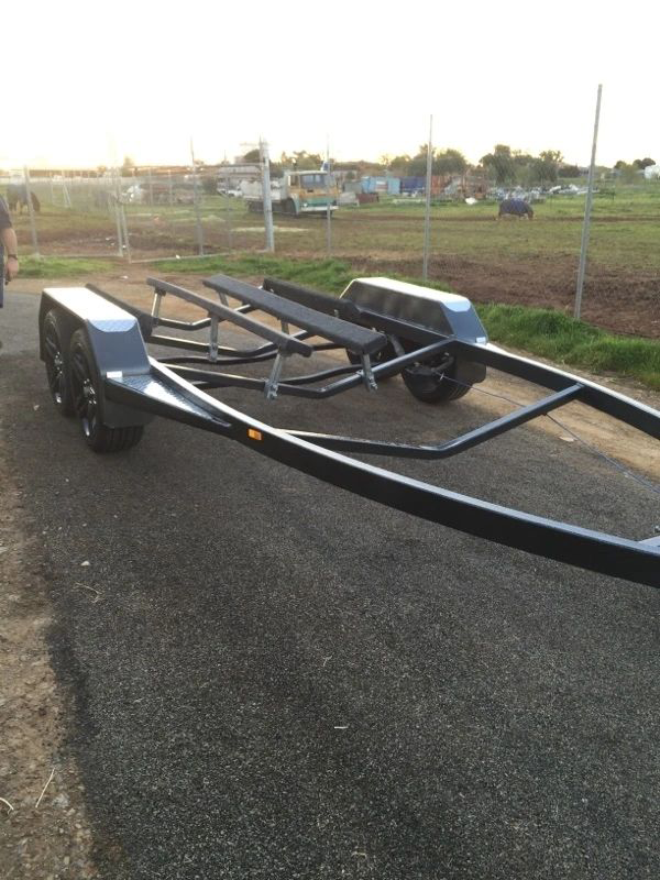 A trailer with a picnic table on it is parked on the side of the road