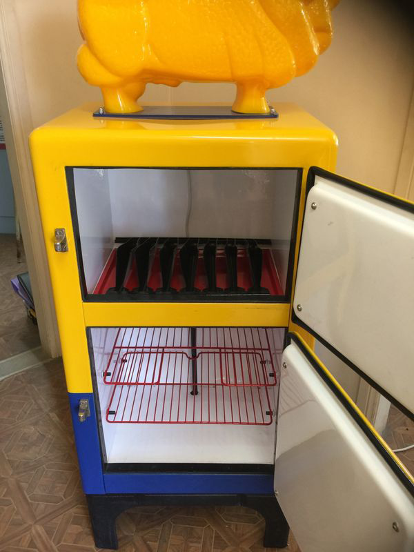A yellow and blue refrigerator with the door open