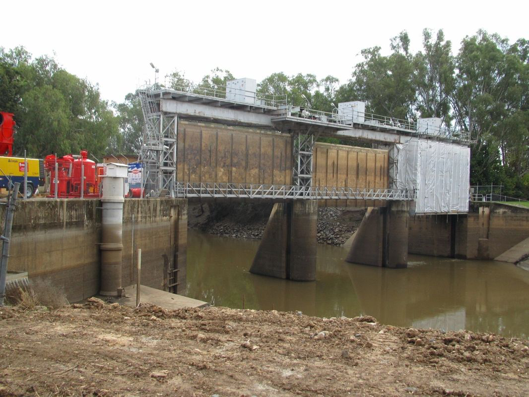 A large bridge over a body of water with trees in the background.