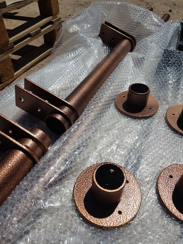 A bunch of metal pipes sitting on top of bubble wrap