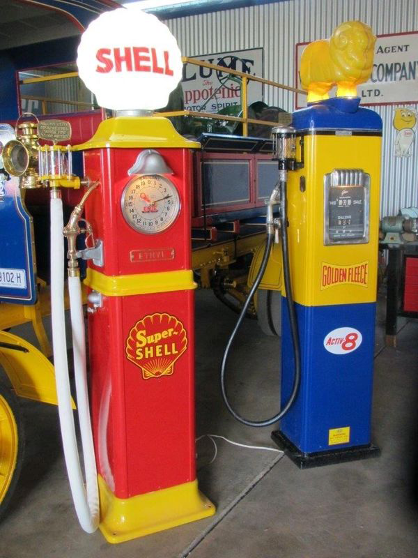 A red and yellow gas pump with the word shell on it