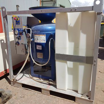 A blue tank is sitting on top of a pallet next to a white tank