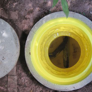 A close up of a hole in the ground with a yellow ring around it.